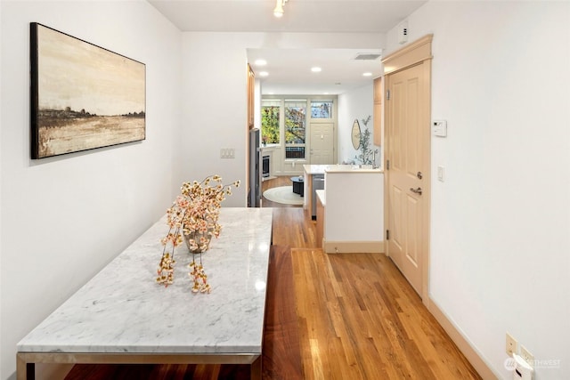 hall with light hardwood / wood-style floors