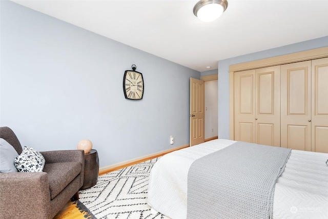 bedroom with hardwood / wood-style flooring and a closet