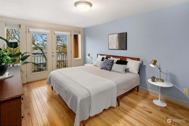 bedroom featuring access to exterior and light hardwood / wood-style flooring