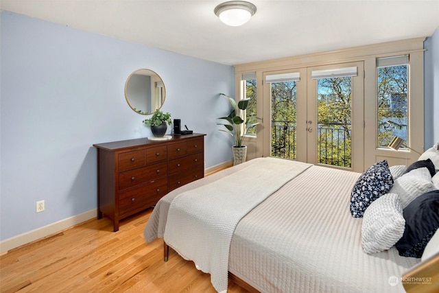 bedroom featuring french doors, access to outside, and light hardwood / wood-style flooring