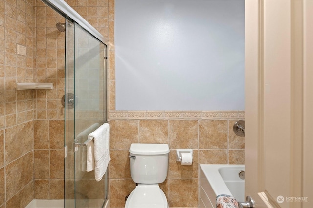 bathroom with plus walk in shower, toilet, and tile walls