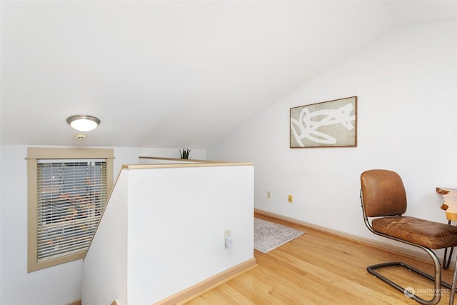 sitting room with vaulted ceiling and hardwood / wood-style flooring