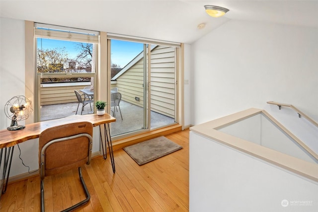 office space with hardwood / wood-style flooring, plenty of natural light, and vaulted ceiling