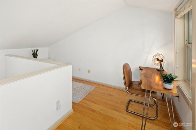 interior space with light hardwood / wood-style floors and lofted ceiling