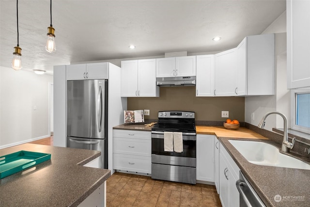 kitchen featuring white cabinets, sink, stainless steel appliances, and hanging light fixtures