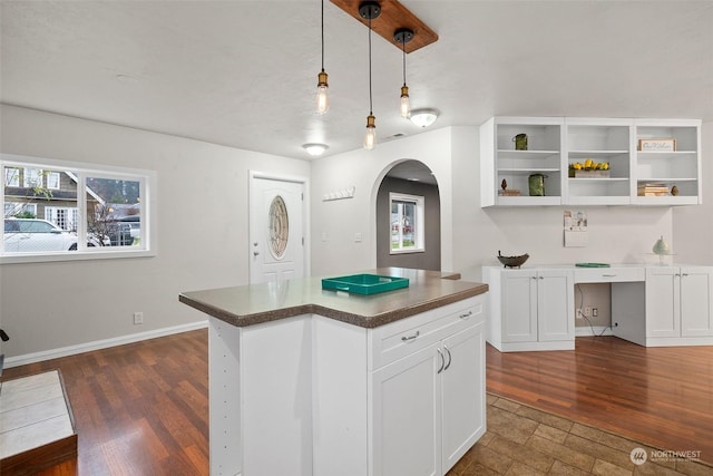 kitchen with white cabinetry, a center island, hanging light fixtures, and dark hardwood / wood-style floors