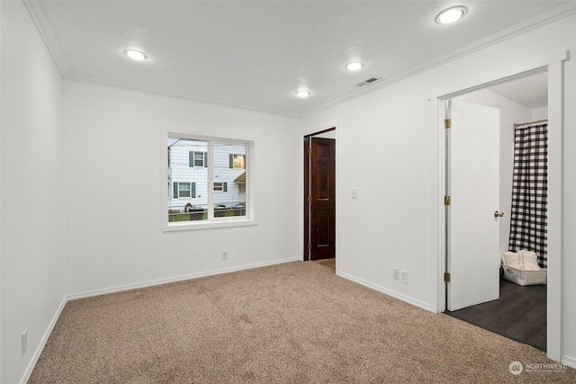 unfurnished bedroom with dark colored carpet and ornamental molding