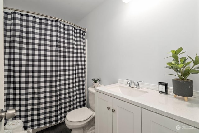 bathroom featuring vanity and toilet