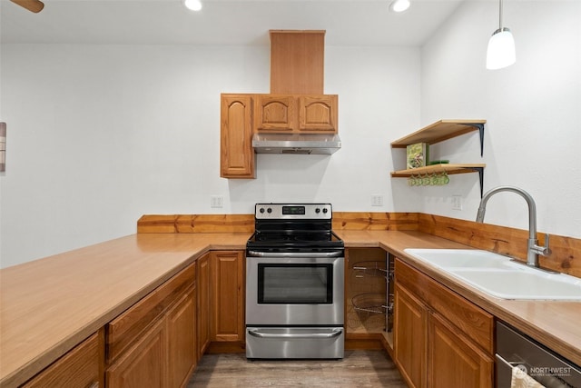 kitchen featuring wood-type flooring, decorative light fixtures, stainless steel appliances, and sink