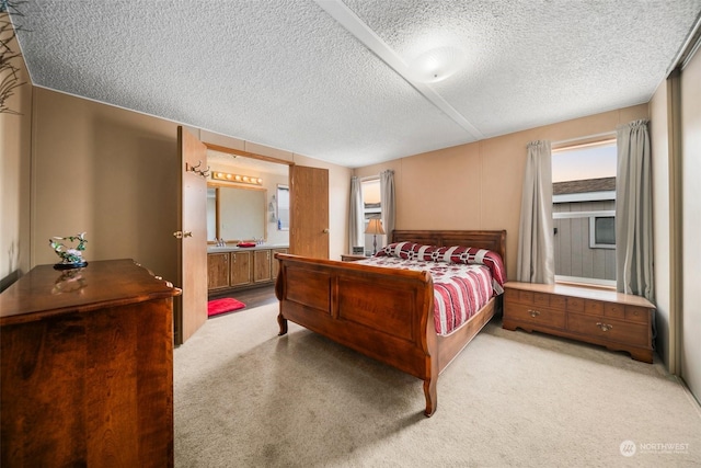 bedroom with light carpet and a textured ceiling