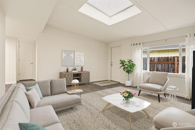 living room featuring wood-type flooring and vaulted ceiling