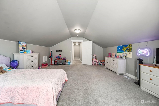 bedroom featuring light colored carpet and vaulted ceiling