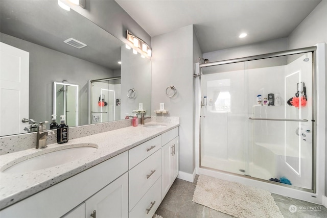 bathroom featuring vanity and an enclosed shower