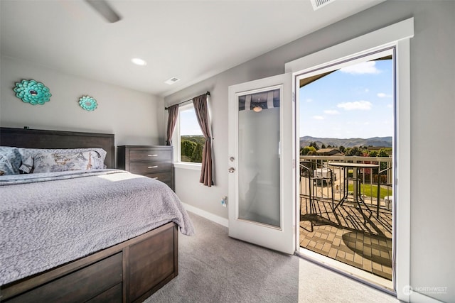 carpeted bedroom featuring access to exterior and a mountain view