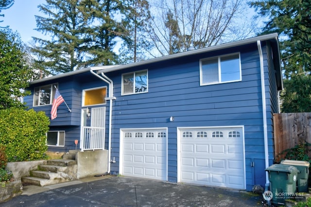 bi-level home featuring driveway and an attached garage