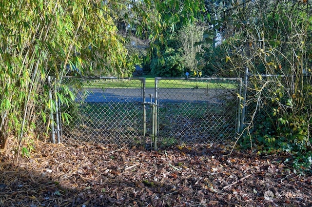 view of sport court with fence and a gate