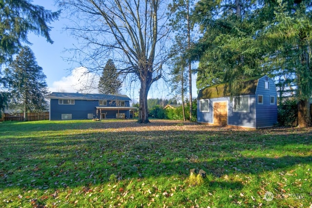 view of yard with fence and an outdoor structure