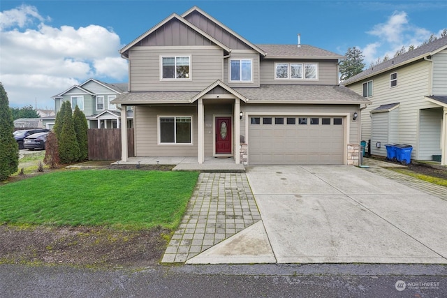 view of front of property featuring a garage and a front lawn