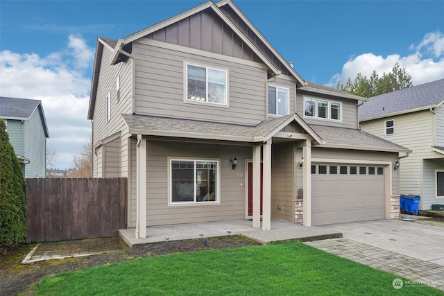 view of front of home featuring a garage and a front lawn