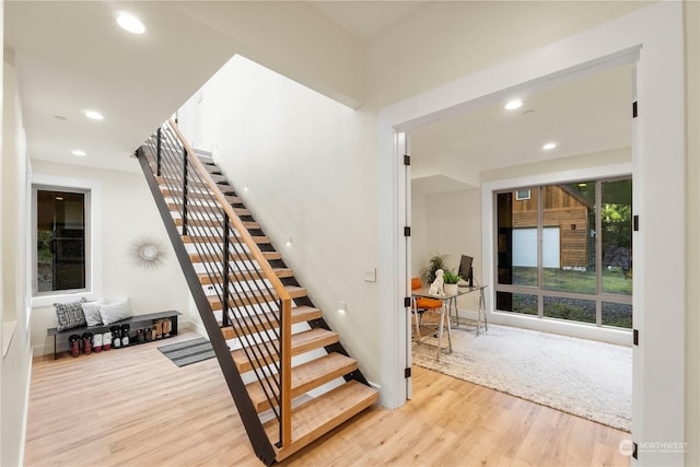 staircase with hardwood / wood-style floors