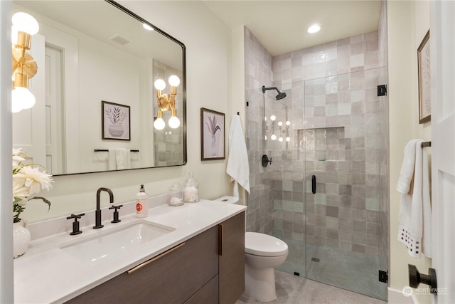 bathroom featuring toilet, vanity, and walk in shower