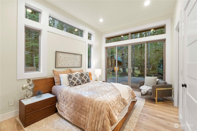 bedroom featuring access to exterior and light hardwood / wood-style flooring