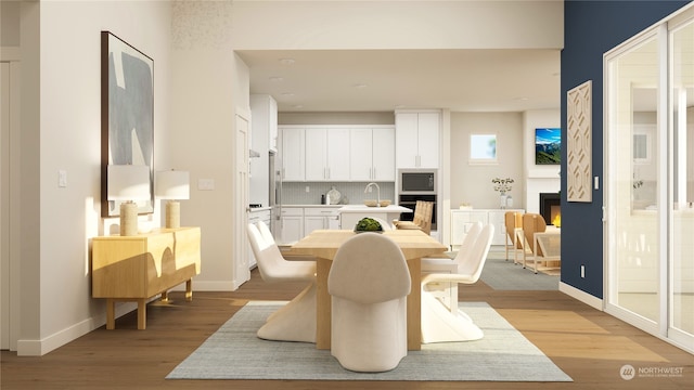 dining space featuring light hardwood / wood-style floors and sink