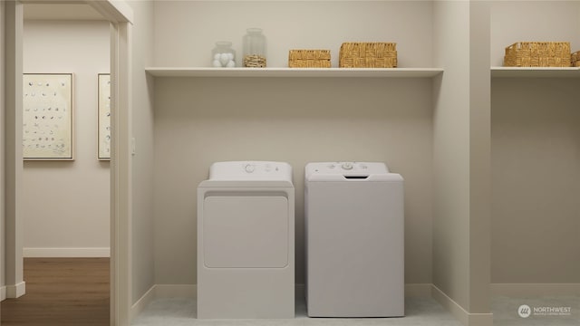 laundry area featuring washer and dryer and wood-type flooring