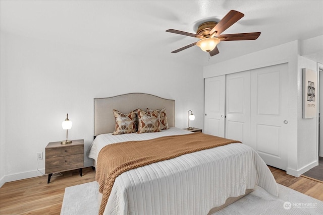 bedroom featuring ceiling fan, light hardwood / wood-style floors, and a closet