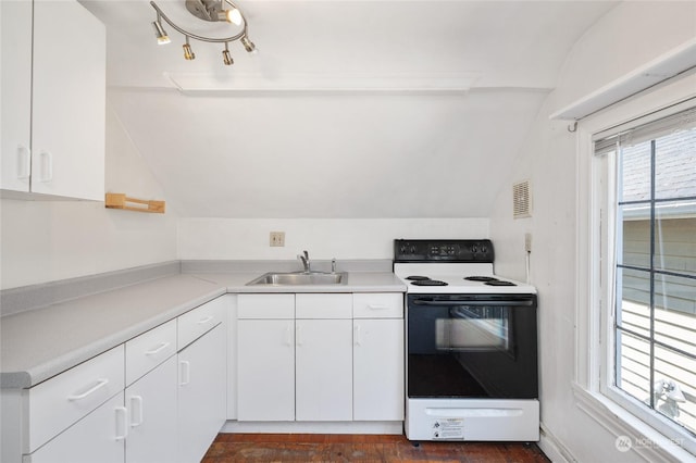 kitchen featuring white cabinetry, white range with electric cooktop, lofted ceiling, and sink