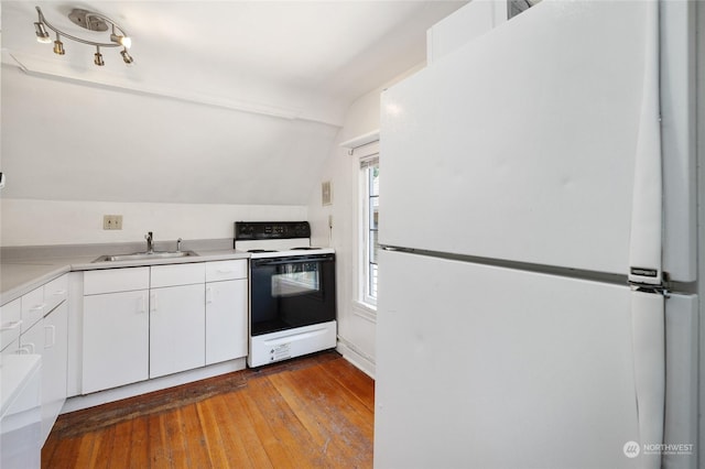 kitchen featuring white cabinetry, sink, light hardwood / wood-style floors, vaulted ceiling, and white appliances