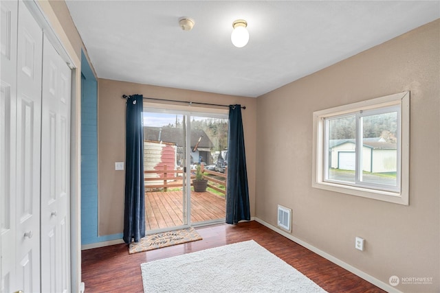 entrance foyer featuring a healthy amount of sunlight and dark hardwood / wood-style floors