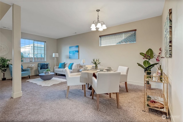 carpeted dining area with a chandelier