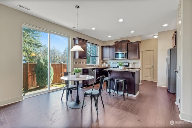 dining room featuring dark hardwood / wood-style floors and sink