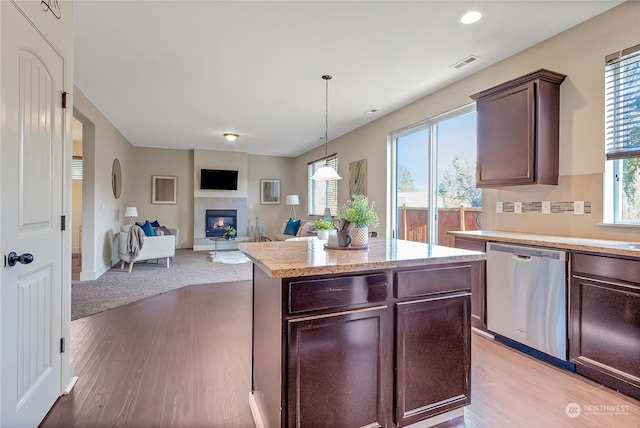 kitchen with dark brown cabinetry, a wealth of natural light, dishwasher, and pendant lighting