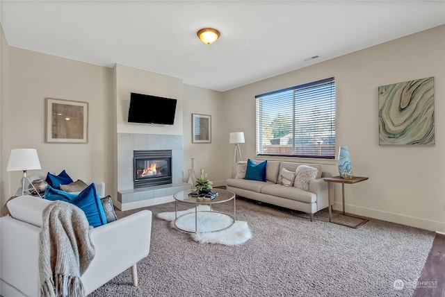 living room featuring a tiled fireplace