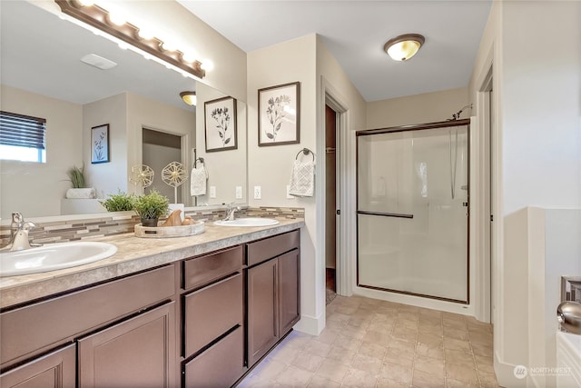 bathroom featuring vanity and a shower with door