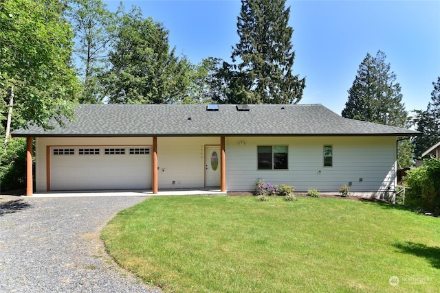 ranch-style house with a garage and a front lawn