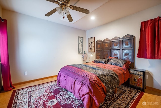 bedroom with ceiling fan and wood-type flooring