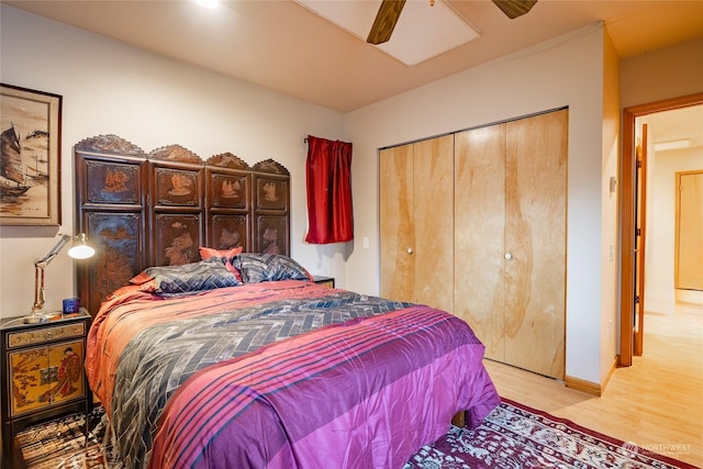 bedroom with ceiling fan, a closet, and light hardwood / wood-style floors