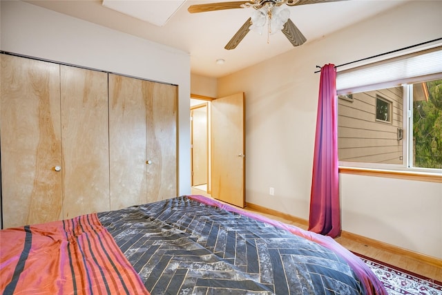 unfurnished bedroom with ceiling fan, wood-type flooring, and a closet