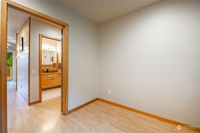 unfurnished room featuring light hardwood / wood-style floors and sink