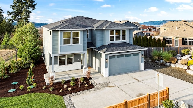 front of property featuring a mountain view and a garage