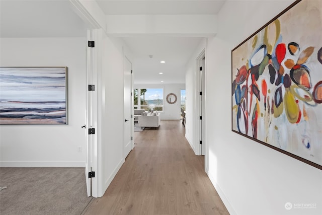 hallway with light hardwood / wood-style floors