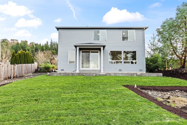 back of house with a lawn