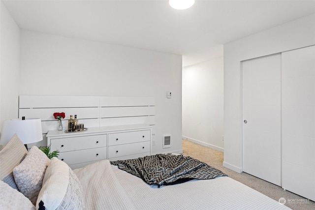 carpeted bedroom with a closet