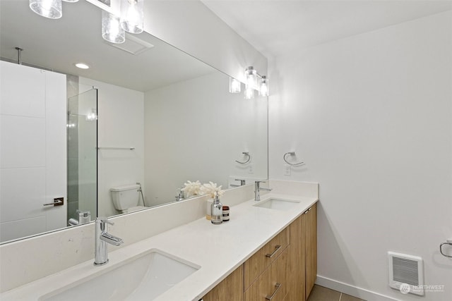 bathroom with toilet, tile patterned flooring, and vanity