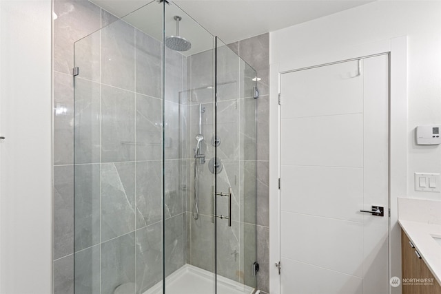 bathroom featuring an enclosed shower and vanity