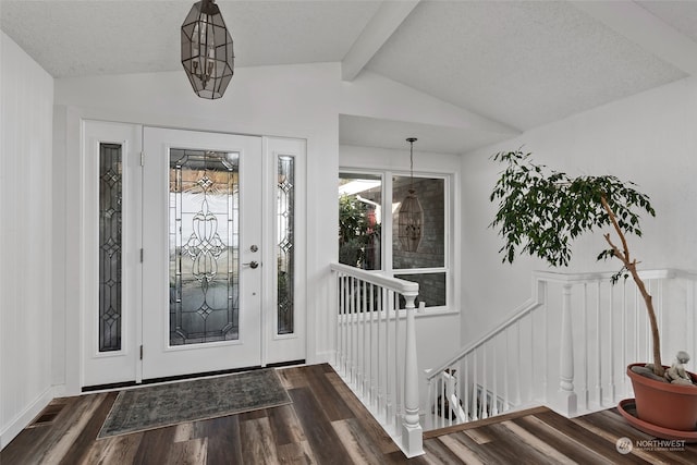 foyer featuring a textured ceiling, vaulted ceiling with beams, and dark hardwood / wood-style floors