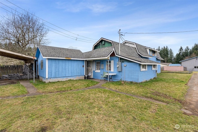 rear view of house featuring a lawn